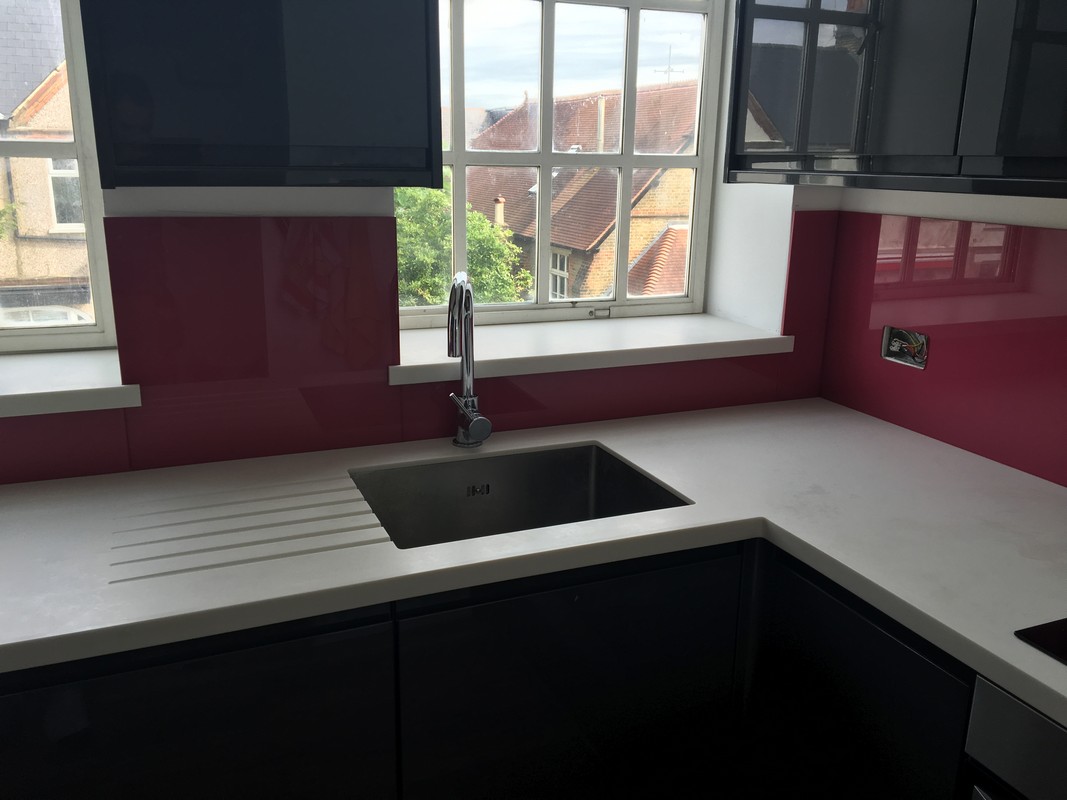 Deep plum coloured glass splashback in modern Kensal Green kitchen
